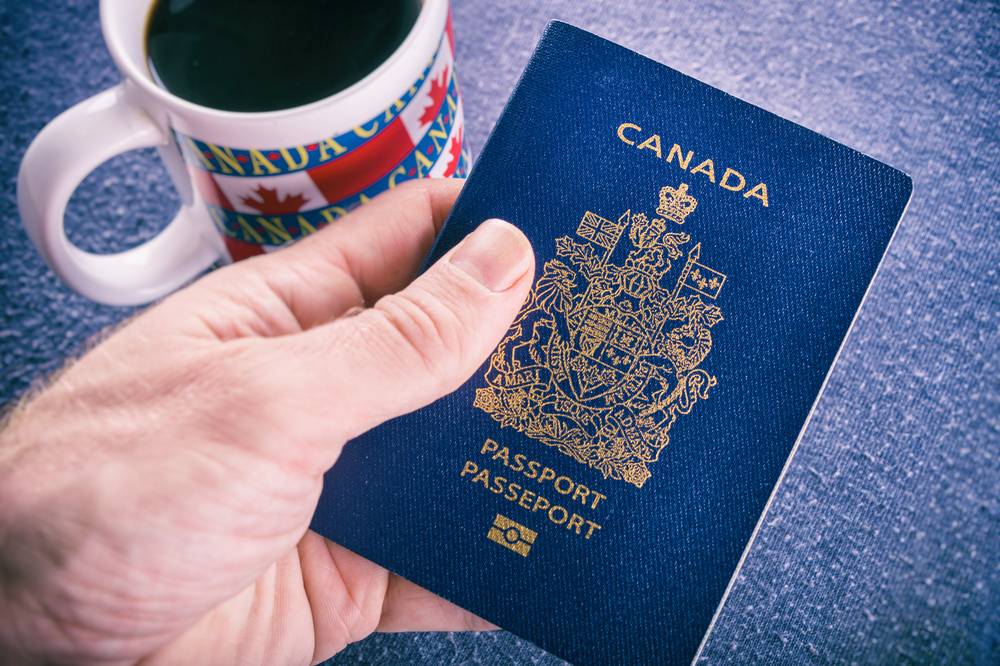 Important Skills for Immigrants in Canada: A hand holding a Canada Passport