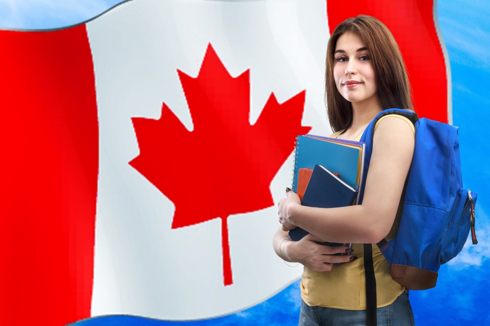Canada Student Visa Requirements: A picture showing a student in Canadian university, holding books with Canada flag in the background.