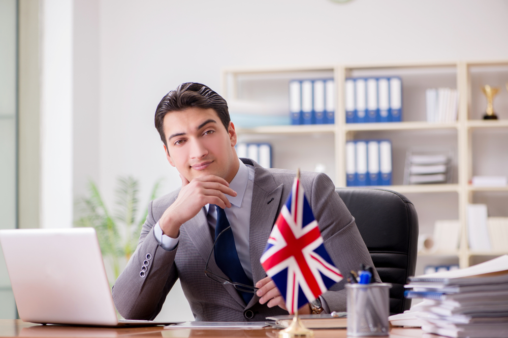 What Not to Do When Negotiating a Job Offer in the UK: Businessman with British flag in the office